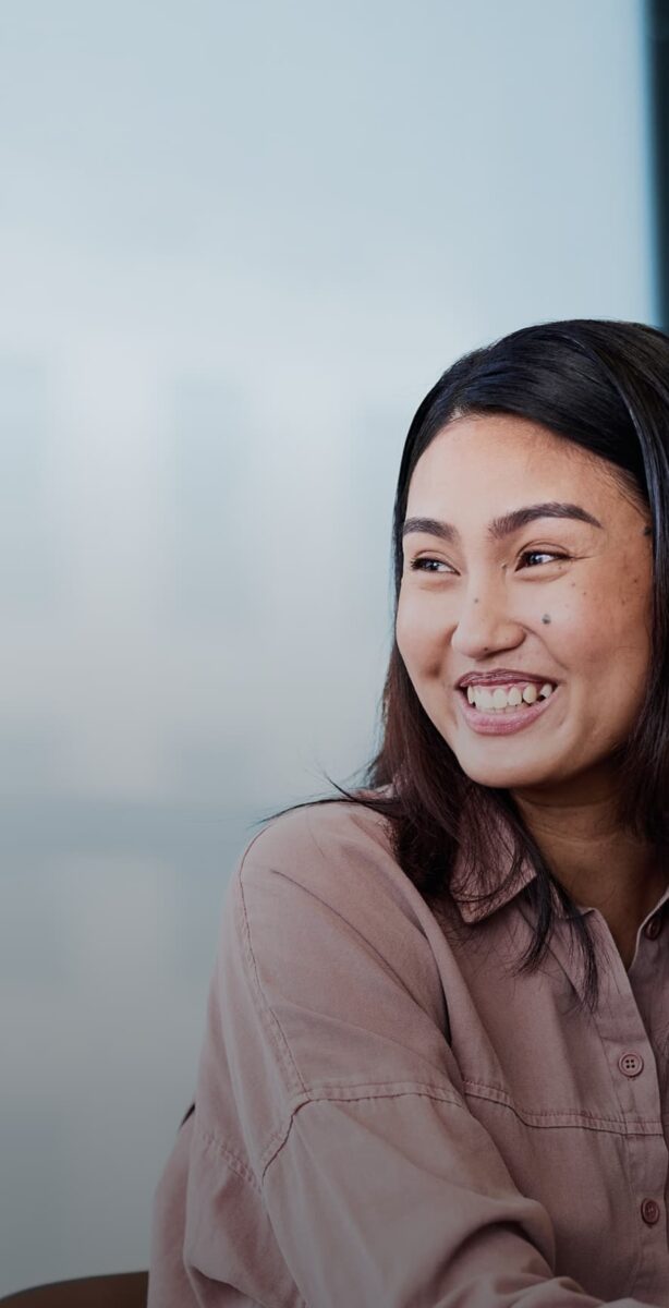 Woman smiles at person unseen