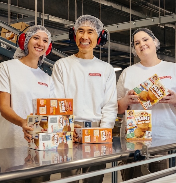 Three McKee coworkers stand in front of McKee products.